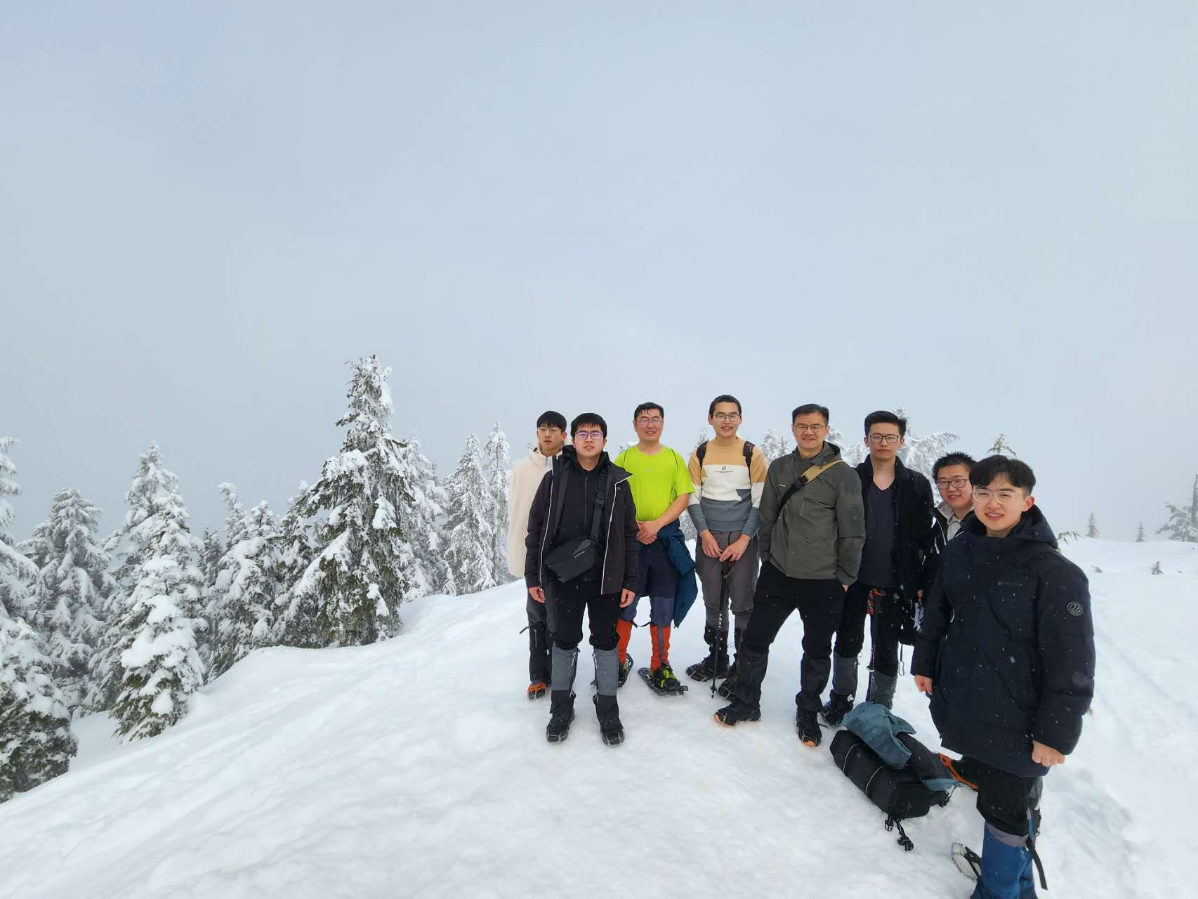 NetMedia Lab members standing together in a snowy mountain landscape.